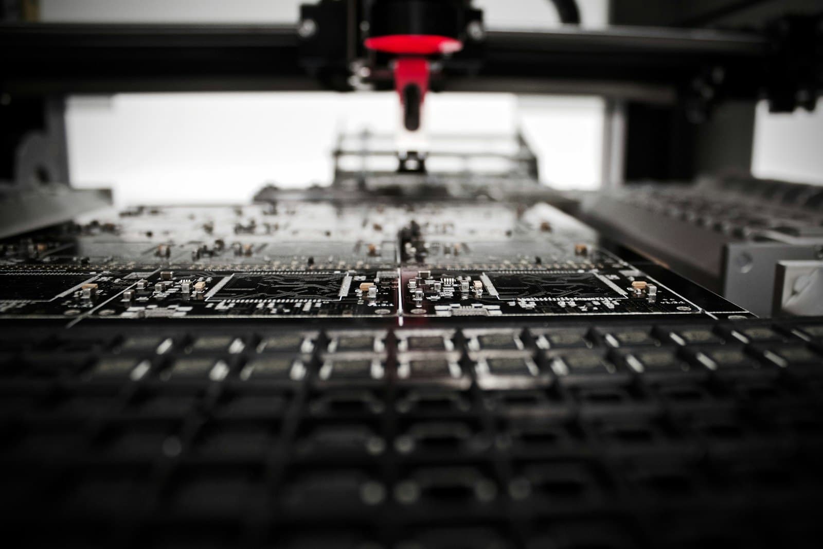 A dispensing head positioned over a circuit board on an assembly machine