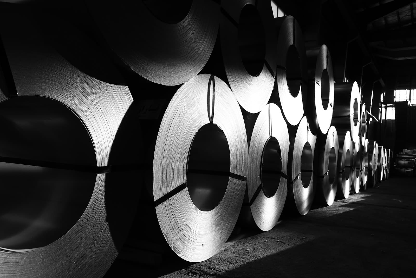 Rows of steel coils standing on edge in a warehouse